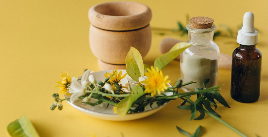 A collection of herbal remedies and natural ingredients on a yellow background, symbolizing holistic health.